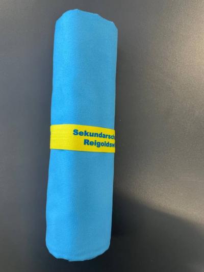 sporttuch-blau-gerollt-mit-werbeaufdruck-juerg-siegrist-ag-1